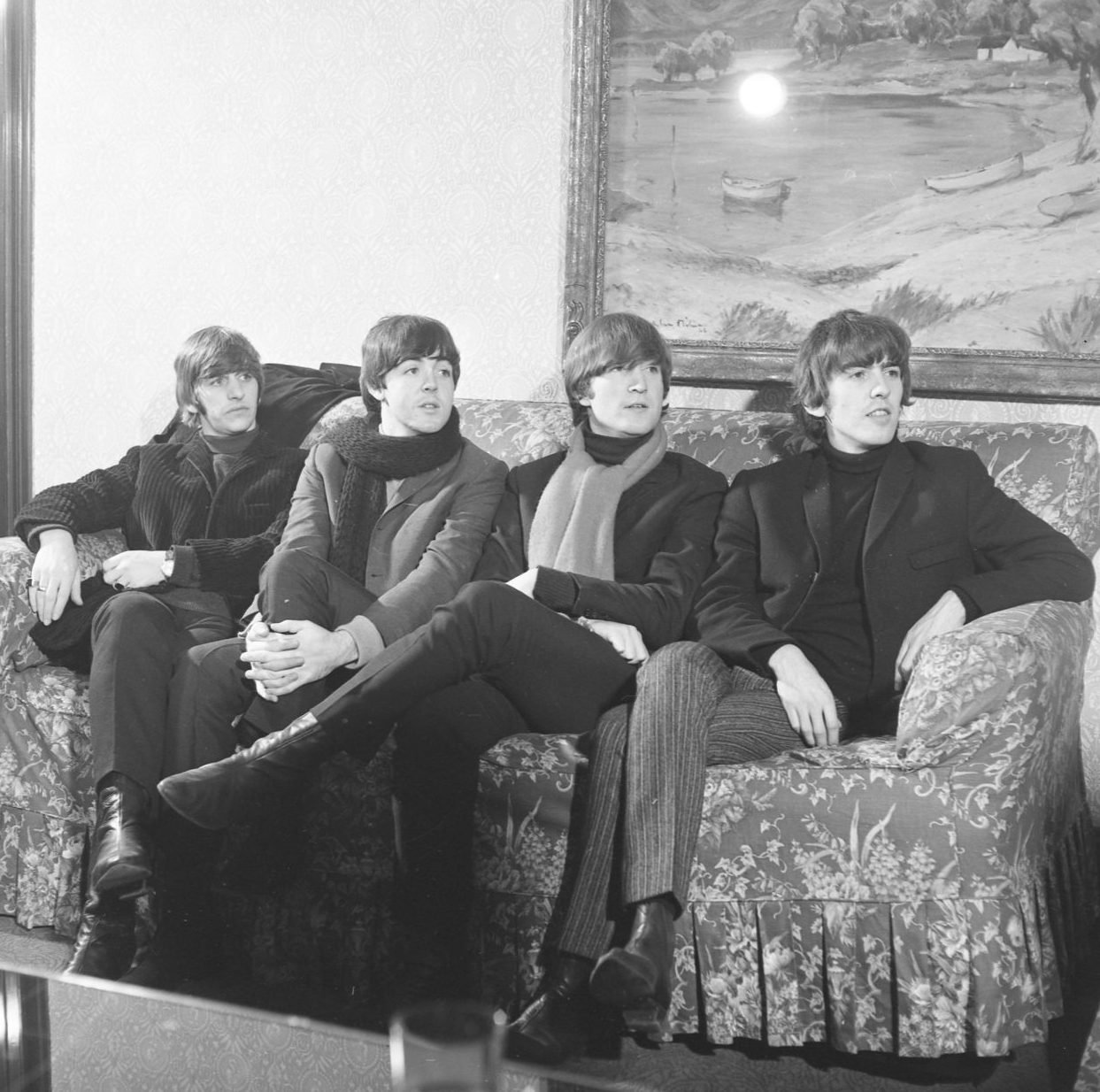 The Beatles sitting on a couch at the Caird Hall in Dundee in October 1964. 