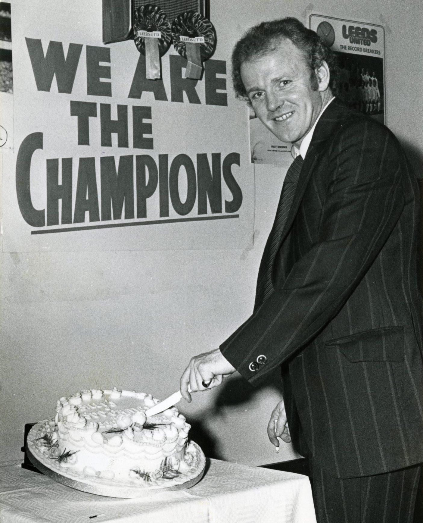 Bremner cuts a cake to mark his 500th game for Leeds in May 1974. 