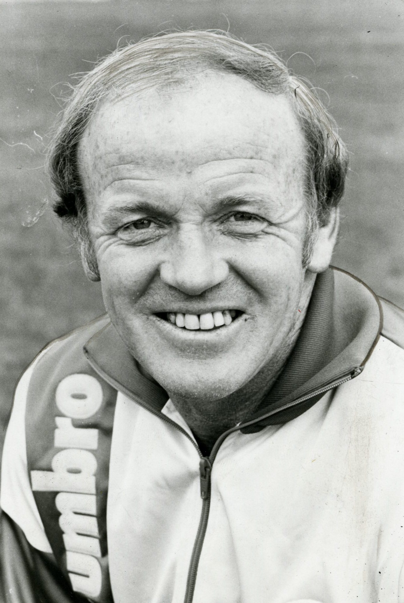 A smiling Billy Bremner in a tracksuit while manager of Leeds United FC in 1986.