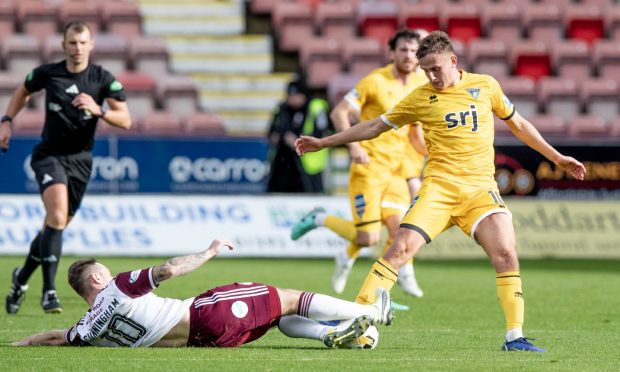 Dunfermline's Matty Todd is challenged by Kelty Hearts' Ross Cunningham.