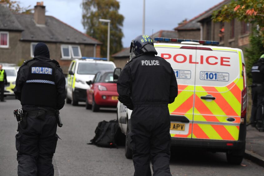 Police in riot gear at the scene on Haig Crescent. 