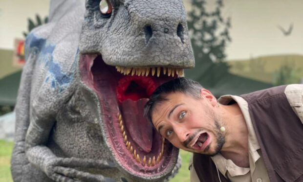 Dinosaur model with man's head in the mouth. For What's On Perthshire,