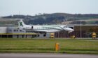 The plane carrying the body of former first minister of Scotland Alex Salmond lands at Aberdeen Airport. Image: PA