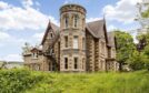 Dunolly House with three storey turret in grounds at Aberfeldy