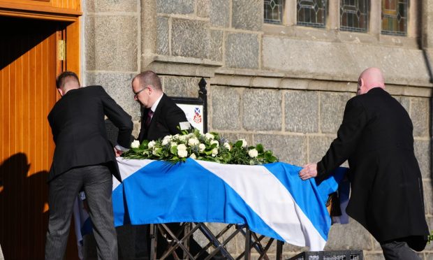 Pall bearers with the coffin, draped in a Saltire flag, arriving for the funeral service for former first minister of Scotland Alex Salmond, at Strichen Parish Church in Strichen, Fraserburgh. The former Alba Party and SNP leader died of a heart attack while attending a conference in North Macedonia earlier this month. Picture date: Tuesday October 29, 2024. PA Photo. See PA story FUNERAL Salmond. Photo credit should read: Andrew Milligan/PA Wire