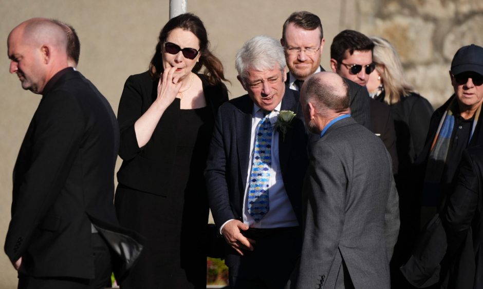 Former SNP MP Eilidh Whiteford and former Commons speaker John Bercow (centre) arrive for the funeral service at Strichen Parish Church in Strichen.