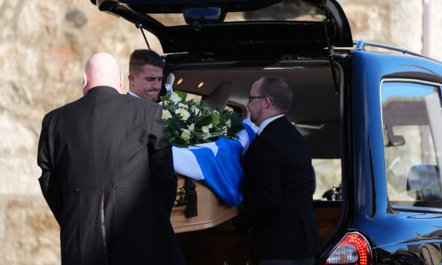 Alex Salmond's coffin arrives at Strichen Parish Church. Image: PA.