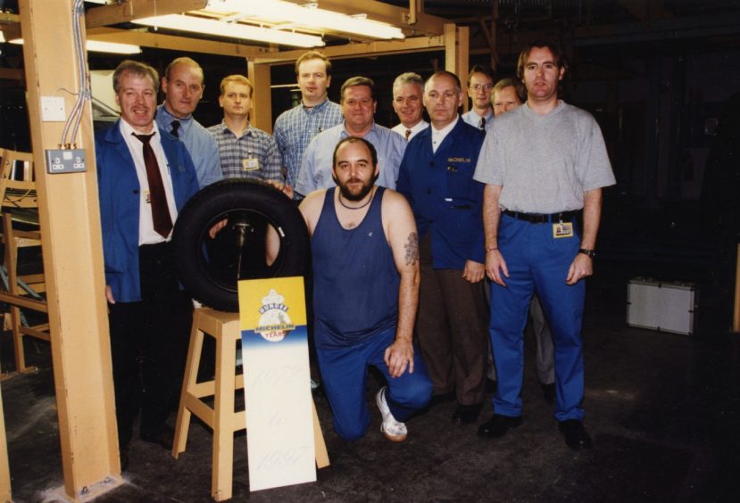 John Greig and colleagues with Michelin's anniversary tyre in 1997.