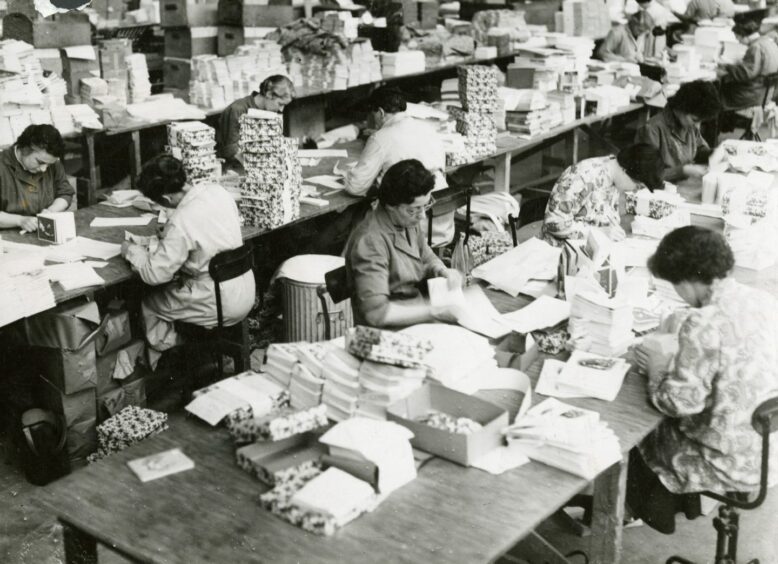 Staff working at long tables in the Valentines despatch department in Dundee in 1956. 