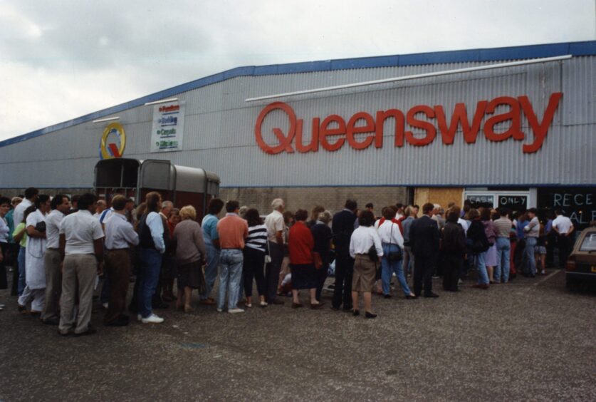 A crowd outside Queensway in August 1990 