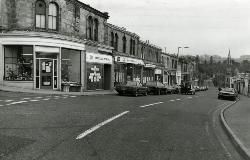 cars parked outside the shops in Newport-on-Tay High Street.