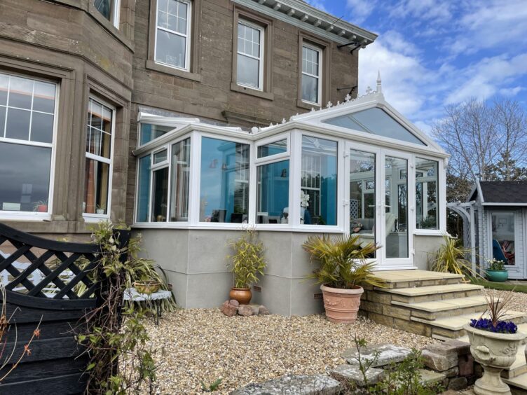 a sunroom on a stone built house