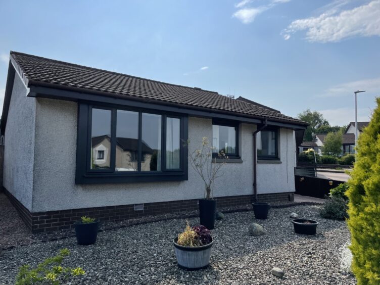 a bungalow with black framed double glazed windows