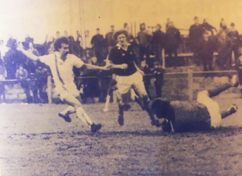 John Mitchell in action for Forfar Athletic FC at Station Park, running as the goalkeeper gathers the ball and a defender looks on