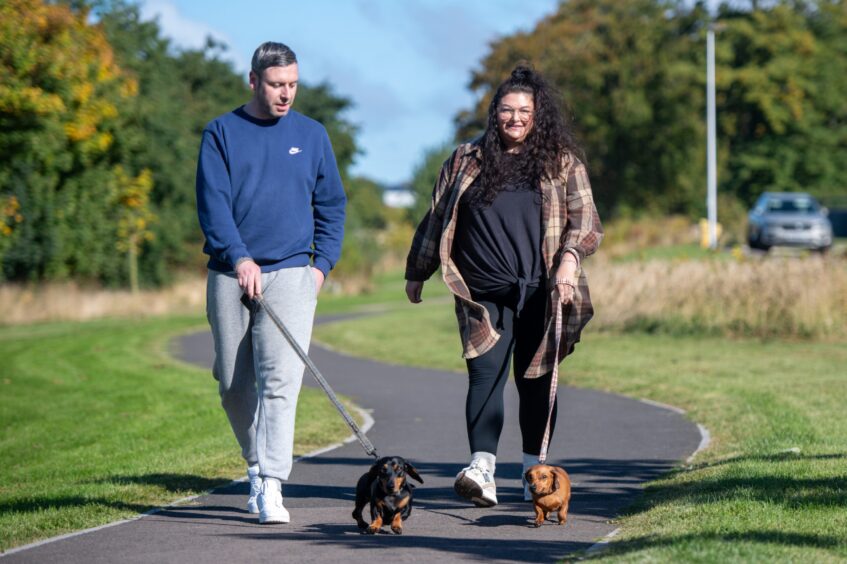 Ross Archbold and Angie Munro with Chester and Olive the sausage dogs in Arbroath. Image: Kim Cessford. 