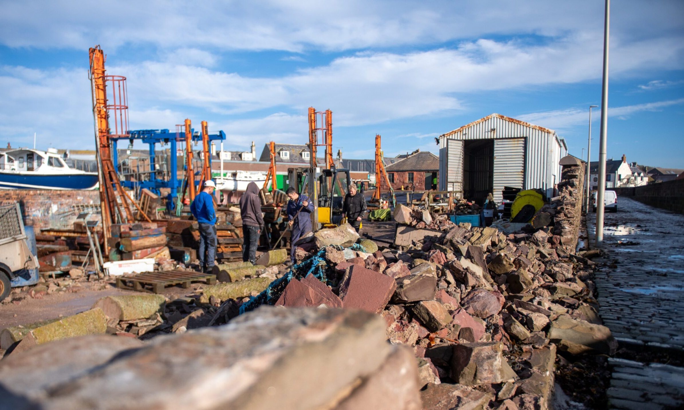 Staff at Mackays Boatyard clearing the damage at Arbroath Harbour