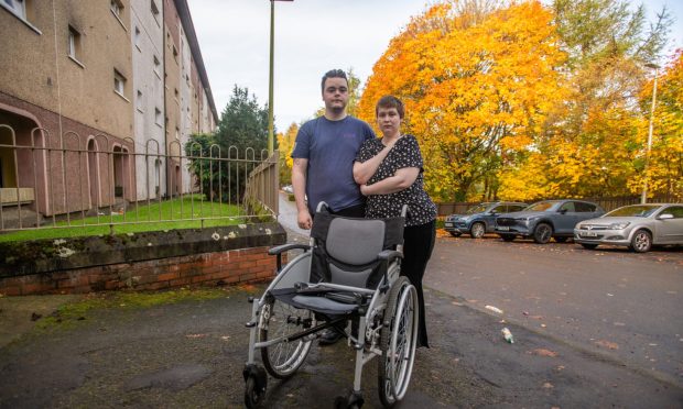 Chris Webster and River Dodds with the damaged wheelchair. Image: Kim Cessford/DC Thomson