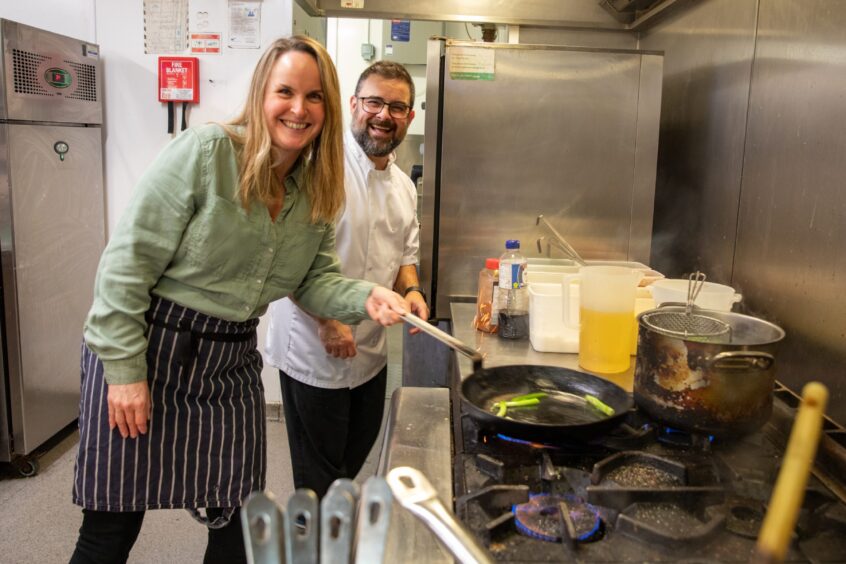 Food and drink writer Rachel frying some spring onions with chef Jesse in his whites at The Meadowpark.