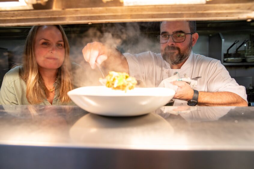 Chef Jesse spoons the steaming fried rice onto a warm plate on the pass.