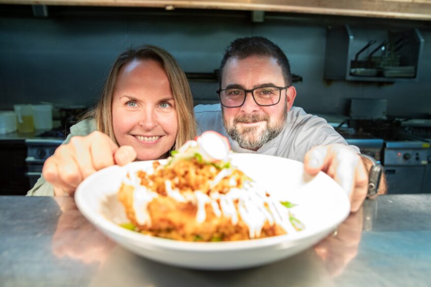 Rachel and Jesse present their dish of fried rice and crispy chicken at the pass.