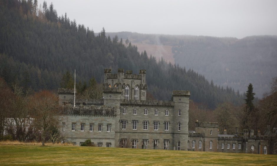 Taymouth Castle exterior with forests and mountains behind