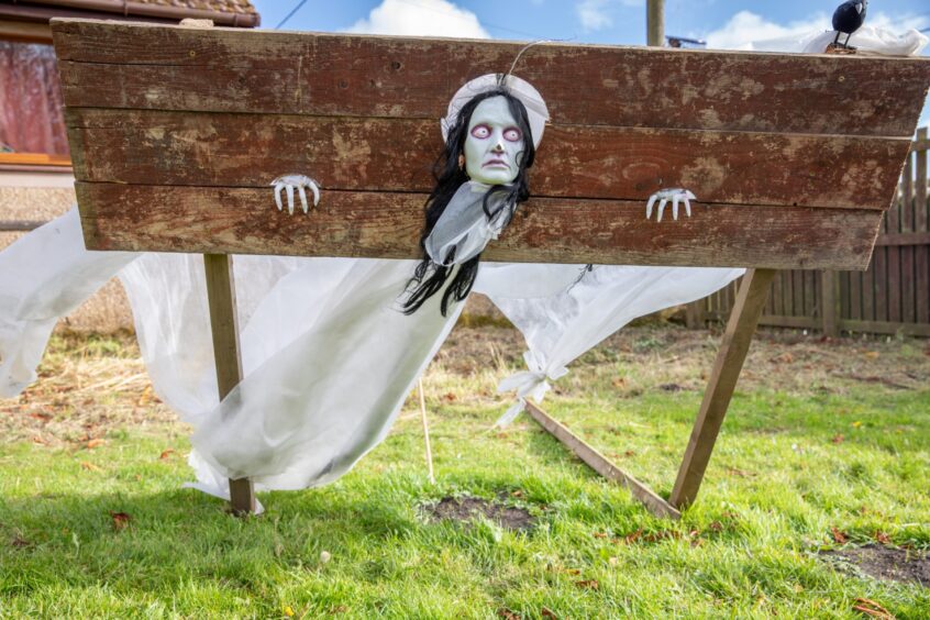 Image shows: a Halloween character with their head in wooden stocks for New Gilston's Halloween event.