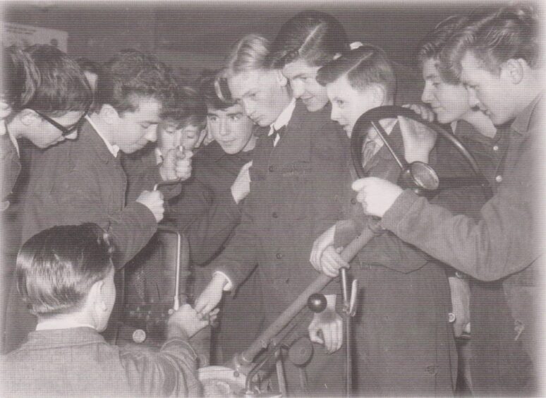 Motor course apprentices, one holding a steering wheel, in 1960 at Lauder College.