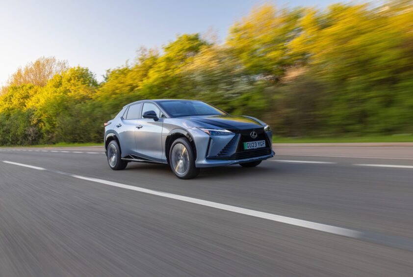 the car on the move with trees in the background