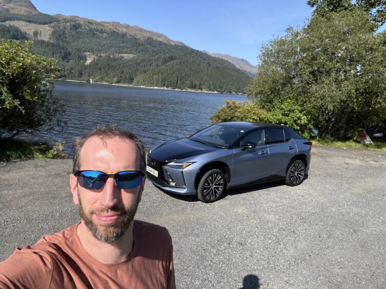 Jack McKeown and the Lexus RZ 300e beside Gare Loch on a sunny afternoon