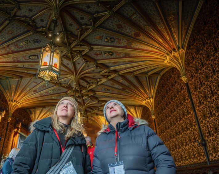 People looking up at ornate ceiling inside Taymouth Castle