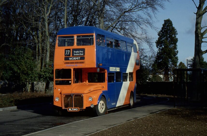 an orange and blue Strathtay Routemaster bus sits at the Ashludie turning point