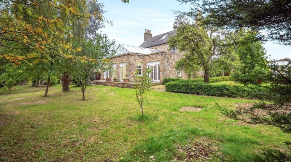 A lawn garden sits to the rear of the home.