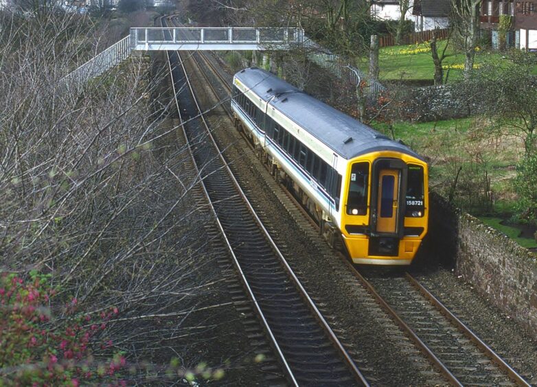 No. 158721 in Broughty Ferry going under the footbridge. 