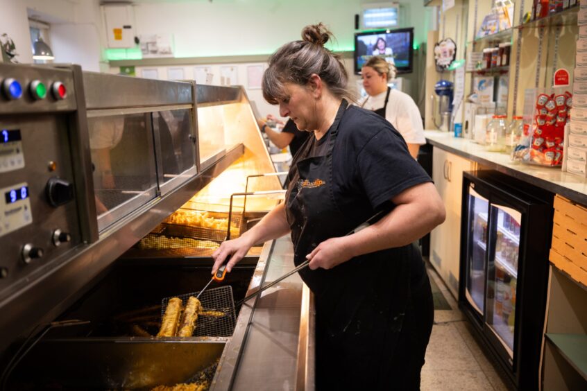 Gillian Whitelaw frying fish and chops at her shop in Auchterarder