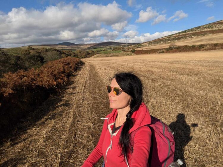 Gayle walks in a stubble field beside West Water at Pirner's. Image: Gayle Ritchie.