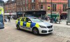 Police parked outside the Wellgate on Panmure Street after alleged shoplifting