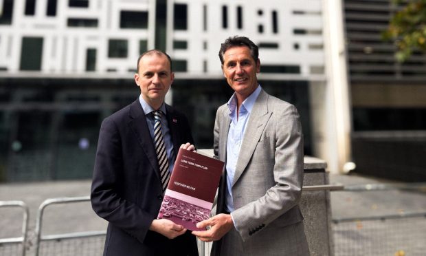 Stephen Gethins MP and Arbroath Town Board chairman Peter Stirling deliver the plan in London. Image: Supplied