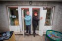 ALan Morgan and Donna Gibson with metal flood barriers whivh they place against the doors of ABC Nursery, Perth