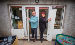 ALan Morgan and Donna Gibson with metal flood barriers whivh they place against the doors of ABC Nursery, Perth