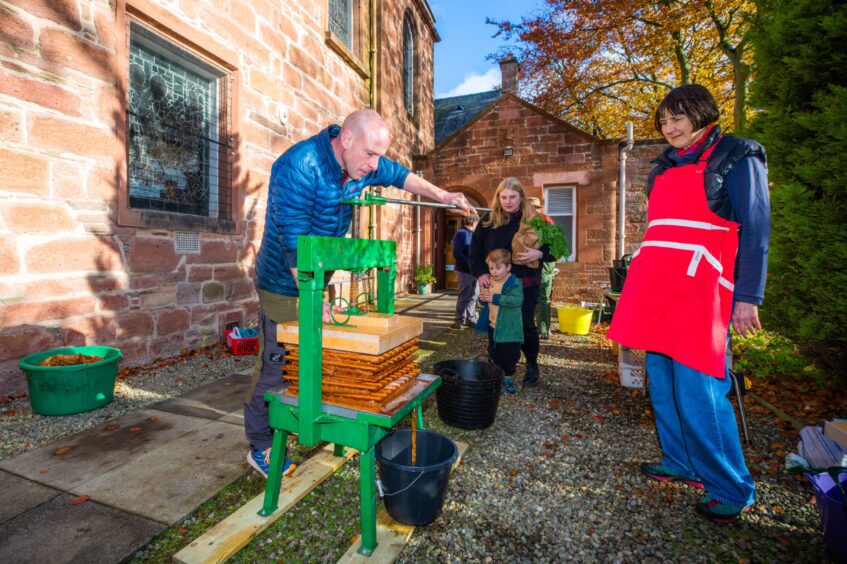 Pressing apples at Sustainable Kirriemuir apple day event.