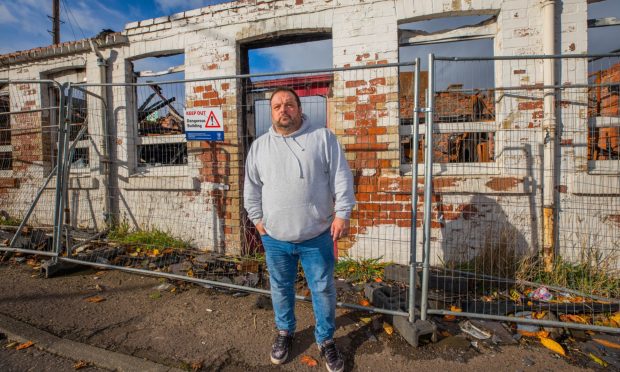 Chris Menday standing in front of the former Blair's Laundry site.