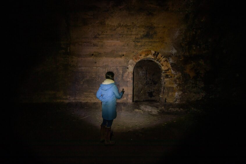 Gayle checks out an old inspection hole within the south railway tunnel at Glenfarg.