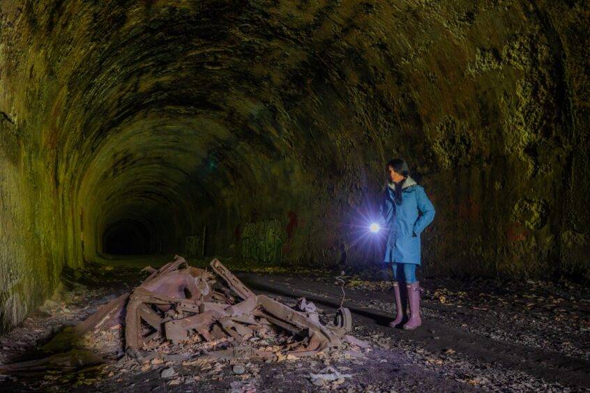 Gayle checks out the remains of a burnt-out car. Image: Steve MacDougall.