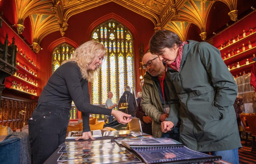 Sarah and Mark Mitchell talk to Zoe Harrigan, conservation manager at Rainbow Glass Studio.