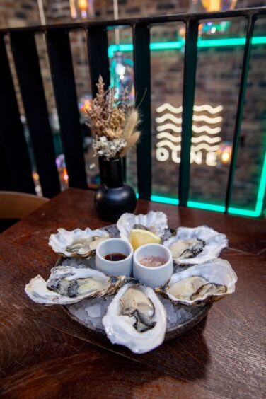 A pate of six chilled oysters with two types of dressings.