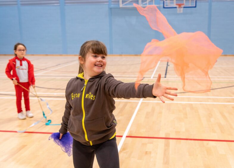 Brownie Olivia from 10th Brownies in Ardler performs with scarfs with Lana of Flying Colours.