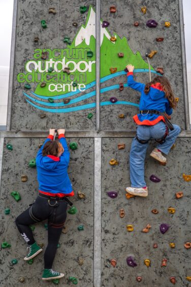 Caitlyn Young and Piper Moir from 34th Girl Guides, Dundee on the climbing wall.