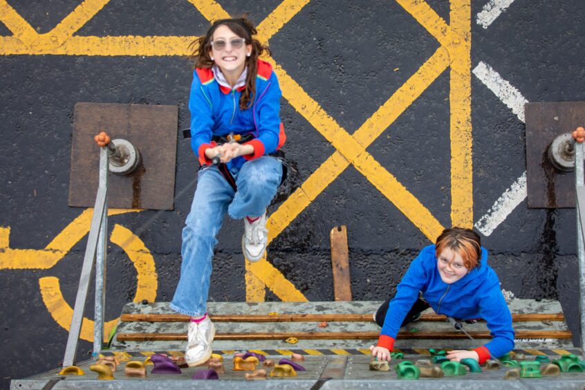 Girl guides Caitlyn Young and Piper Moir trusting the ropes on the climbing wall during Girlguiding Dundee Adventure on your Doorstep.