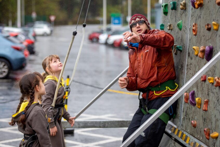 Ant Clark of Ancrum Outdoor Education Centre helps Brownies Indian Bell and LJ Crowe from 10th Rainbows &amp; Brownies Unit in Ardler, Dundee have a go at rock climbing.