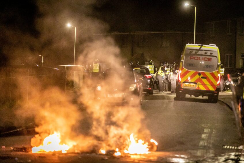 Youths set fire to debris in the street in 2023. 